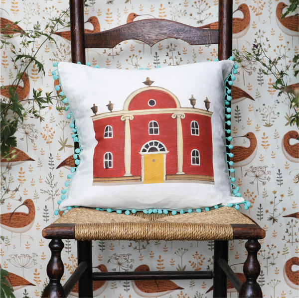 Folly Cushion with blue pom poms